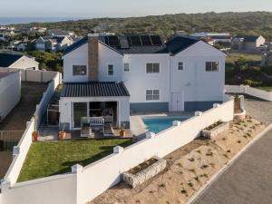 an aerial view of a white house with a swimming pool at Vermont Vista - With Pool in Hermanus