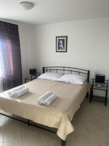 a bedroom with a large bed with towels on it at Apartment Tihana in Cres