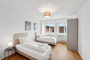 a living room with two beds and a couch at The R Apartment Hagen in Schaffhausen +14 photos