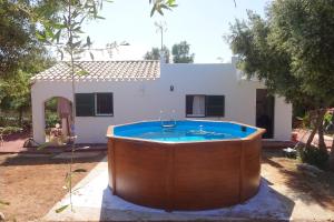 a hot tub in front of a house at Vinya Alice in Ciutadella