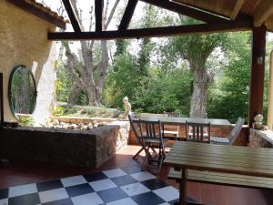 a patio with a table and chairs and a fountain at Centre Les Labadous in Rennes-le-Château