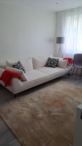 a white couch sitting in a living room at Virmalise apartments in Tallinn