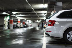 a white car parked in a parking garage at Hotel Bologna in Prague