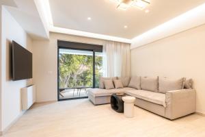 a living room with a couch and a tv at D&R Boutique Apartments Central in Rhodes Town