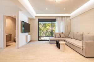 a living room with a couch and a tv at D&R Boutique Apartments Central in Rhodes Town