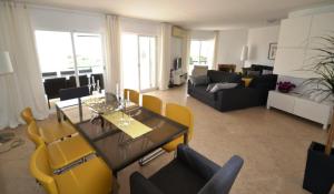 - un salon avec une table et des chaises jaunes dans l'établissement Nautilus Apartment, à Armação de Pêra