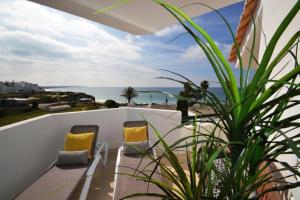 a balcony with chairs and a view of the ocean at Nautilus Apartment in Armação de Pêra