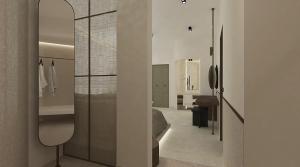 una stanza con un letto, una scrivania e uno specchio di Athiri Santorini Hotel a Imerovigli