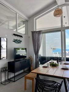 a living room with a wooden table and a television at Slow Living House in Lozenets