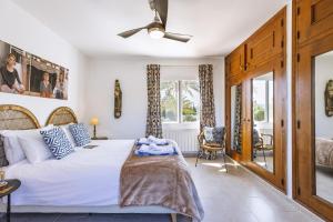 a bedroom with a bed and a ceiling fan at Casa Grande in Jávea +37 photos