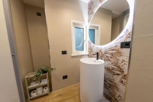 a bathroom with a sink and a mirror at Luxury Room Suites - Santa Maria in Benevento