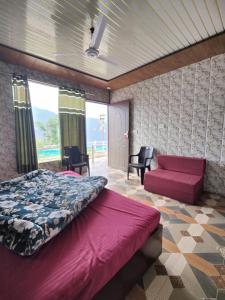 a bedroom with a bed and a red couch at Kedar Avnita Resort in Gupta Kāshi +10 photos