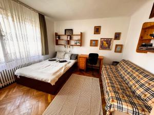 a bedroom with two beds and a desk in it at Rosehill Residence Apartment in Budapest