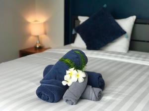 a towel animal with flowers on a bed at Bluefin Hotel Lamai Beach in Lamai