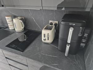 a coffeemaker and other appliances on a counter at MacKaw Flat 2 in Fort William