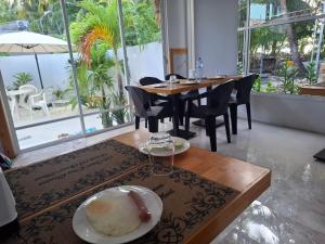 a dining room with a table with a plate of food at Futtaru Sands in Gaafaru