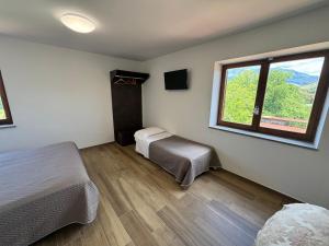 a bedroom with two beds and a window at Agriturismo Barbitto in Sezze