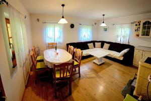 a living room with a table and a couch at Country House Srček in Bizeljsko
