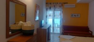 a room with a mirror and a dresser with shoes in it at Paraga Rooms Pefkari in Pefkari