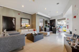 a living room with a couch and a table at White Waters Hotel in Machico