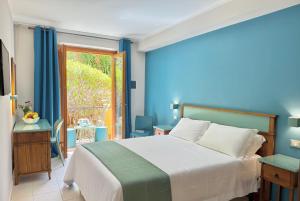 a bedroom with a large bed and a window at HOTIDAY San Vito Lo Capo in San Vito lo Capo