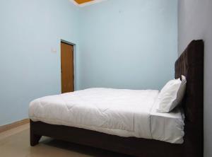 a bedroom with a bed in a blue room at Heritage Hotel in Hardoī +2 photos