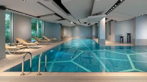 a swimming pool with blue water in a building at Crowne Plaza Florya Istanbul by IHG in Istanbul