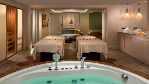 a hotel room with a bath tub and a living room at Crowne Plaza Florya Istanbul by IHG in Istanbul