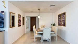 a dining room with a table and chairs at Yas Island Family Nest 4BR in Yas Island