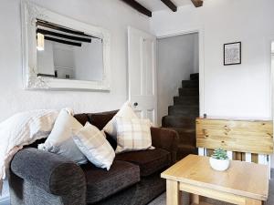 a living room with a couch and a table at The Willow Nook in Pateley Bridge