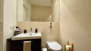 a bathroom with a sink and a toilet and a mirror at Martinengo30 Apartment in Milan +35 photos