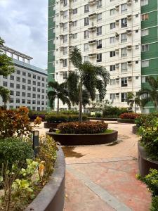a courtyard with a large building in the background at Avida Towers Riala T2, L&D Stays, Coffee Machine in Cebu City