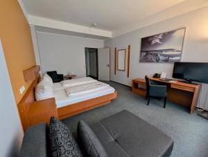 Postel nebo postele na pokoji v ubytování DLRG Tagungszentrum Hotel Delphin + 20 fotografií