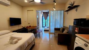 a hotel room with a bed and a living room at THE SHORE KK CITY VIEW S15 By BC 亚比城市景观 in Kota Kinabalu