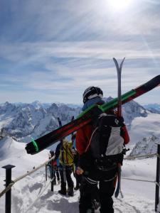 a group of people carrying skis on top of a mountain at Agafay Toubkal View in Imlil +46 photos