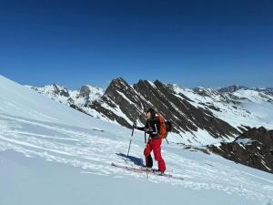 a man on skis on a snow covered mountain at Agafay Toubkal View in Imlil