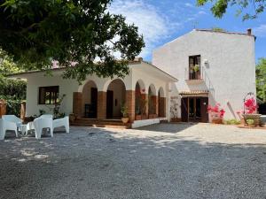 a house with a table and chairs in front of it at Stunning Property with Private Pool in Cefalù in Cefalù