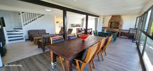 a dining room with a wooden table and chairs at Beachwood Cottage in Margate
