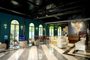 a living room with blue walls and white furniture at LakeSide Hotel by EDEN Group in Tashkent