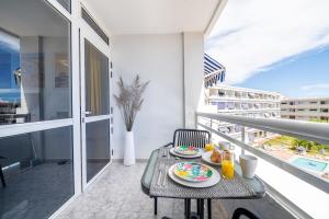 a table with plates of food on a balcony at Holiday Dream Maspalomas in Maspalomas +23 photos