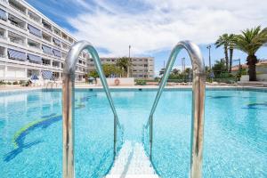 a swimming pool with two metal rails in the water at Holiday Dream Maspalomas in Maspalomas