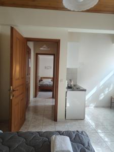 a room with a bed and a kitchen and a door at Filoxenia in Tsagarada +49 photos