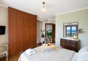 a bedroom with a bed and a table with a tray on it at Aquilina in Apolpaina