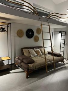 a bedroom with a bunk bed with a clock on the wall at Slow Living House in Lozenets