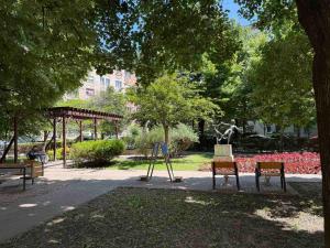 a park with two chairs and a swing at Buda's Crib apartment in Budapest