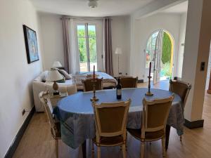 a dining room with a blue table and chairs at Magnifique villa pieds dans l eau Saint Jean Cap Ferrat in Saint-Jean-Cap-Ferrat