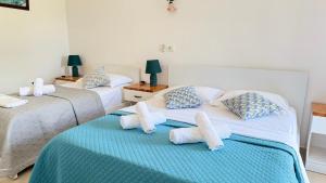 a bedroom with two beds with towels on them at Rida Village Ksamil Island in Ksamil