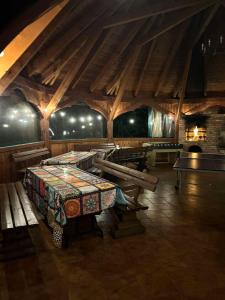 a room with a table and benches in a building at Ranczo Jamidar in Szczytno