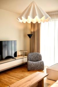 a living room with a chair and a television at Nook in Timişoara