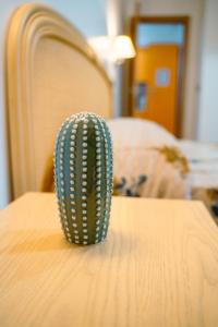 a green cactus sitting on top of a table at Le Tartarughe Aparthotel in Letojanni